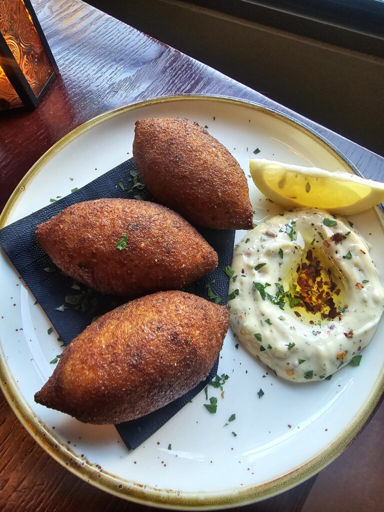Three golden fried croquettes with lemon and herbed aioli at Camp West